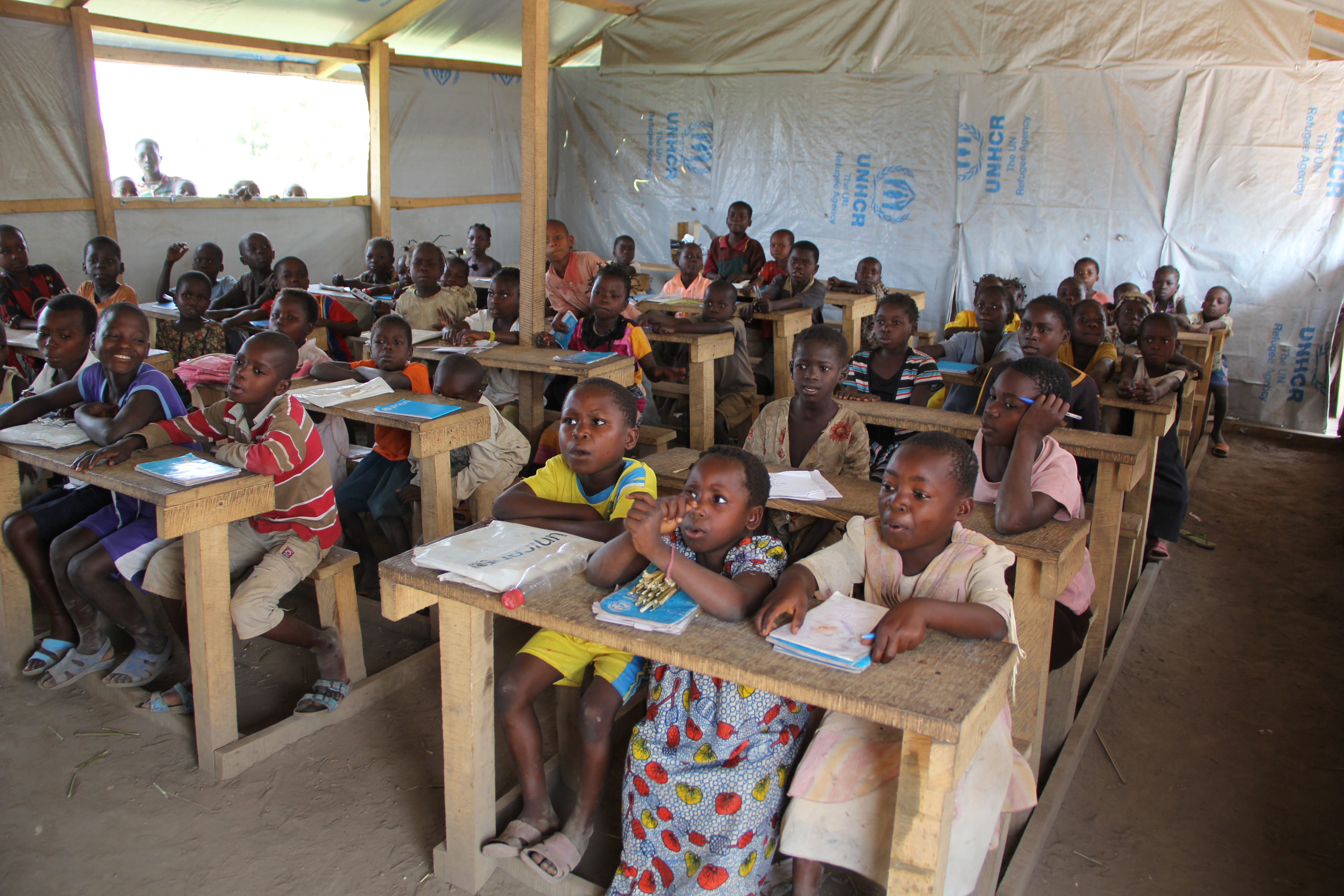 Young african streeft children taking a pottery course - reeducation volunteering